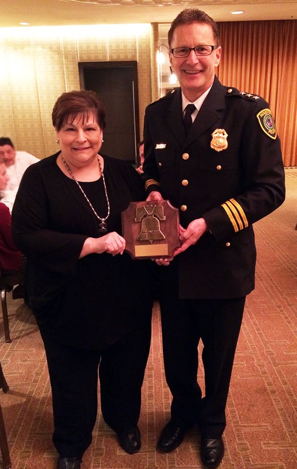 Andrea & Chief Buenik hold award